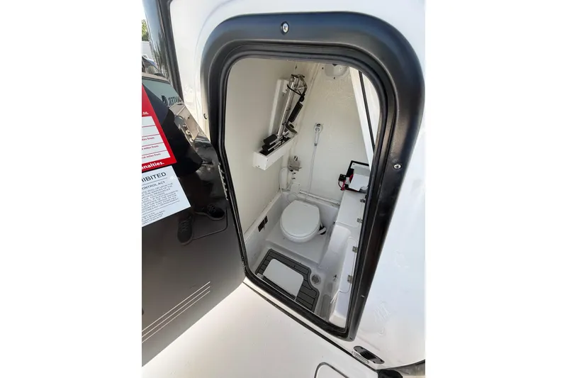Slide: The Image of 2026 Tidewater 256 CC Adventure boat interior with compact marine toilet. - 5