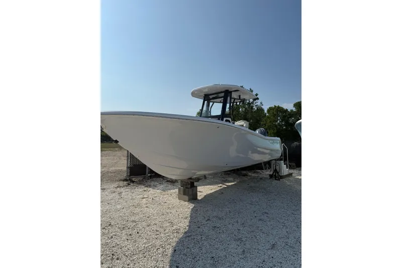 The Image of 2026 Tidewater 256 CC Adventure boat on display in a sunny outdoor setting. - 1