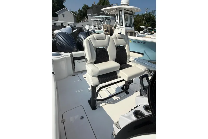Slide: The Image of 2026 Tidewater 256 CC Adventure boat interior with dual seating and modern design. - 7