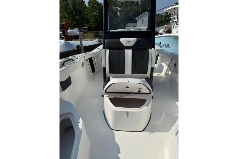 Slide: The Image of 2026 Tidewater 256 CC Adventure boat interior with sleek seating and storage. - 9