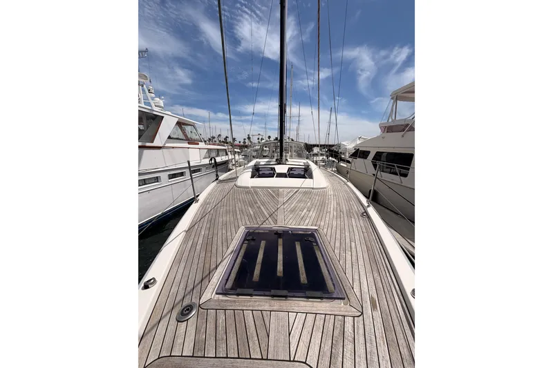 Slide: The Image of 2020 Beneteau Oceanis 51.1 yacht deck with sleek design and clear blue sky. - 20