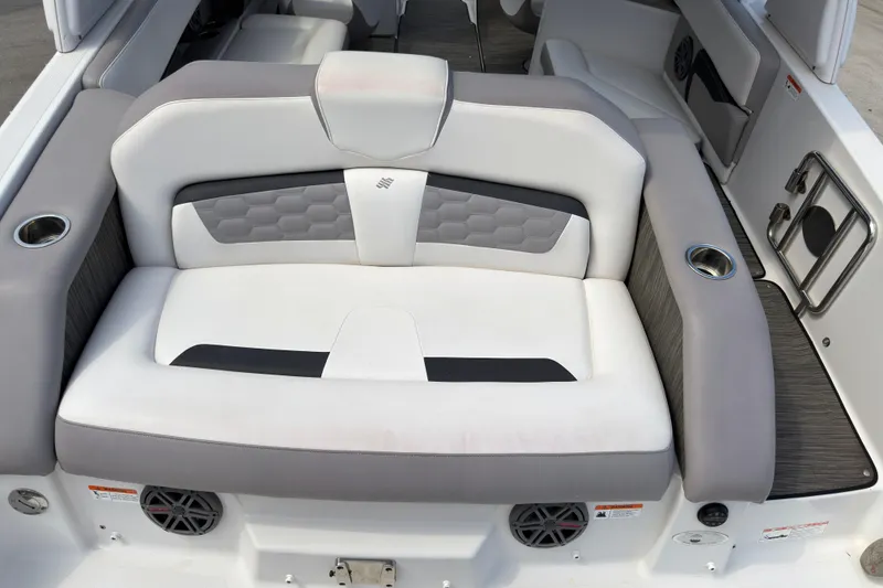 Slide: The Image of 2018 Four Winns HD270 OB boat interior with cushioned seating and cup holders. - 16