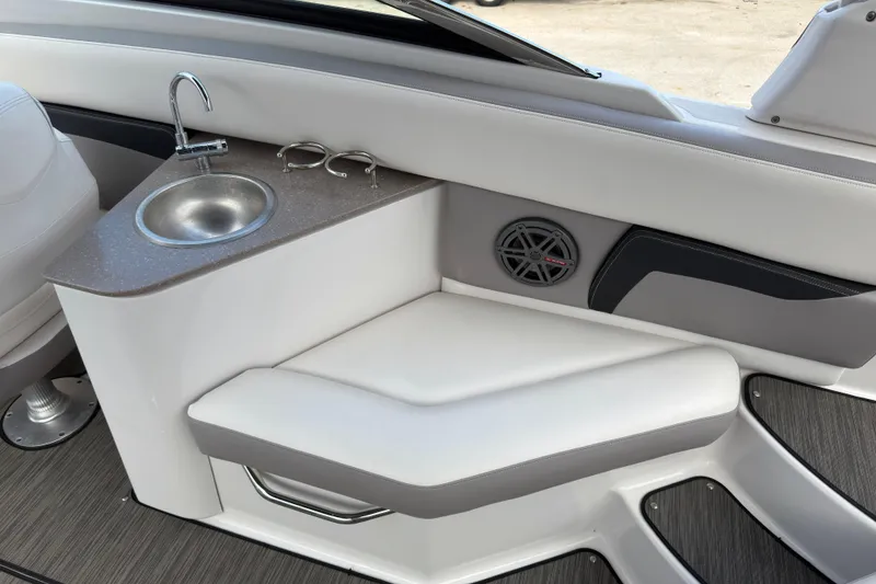 Slide: The Image of Interior of 2018 Four Winns HD270 OB boat with sink and seating area. - 8