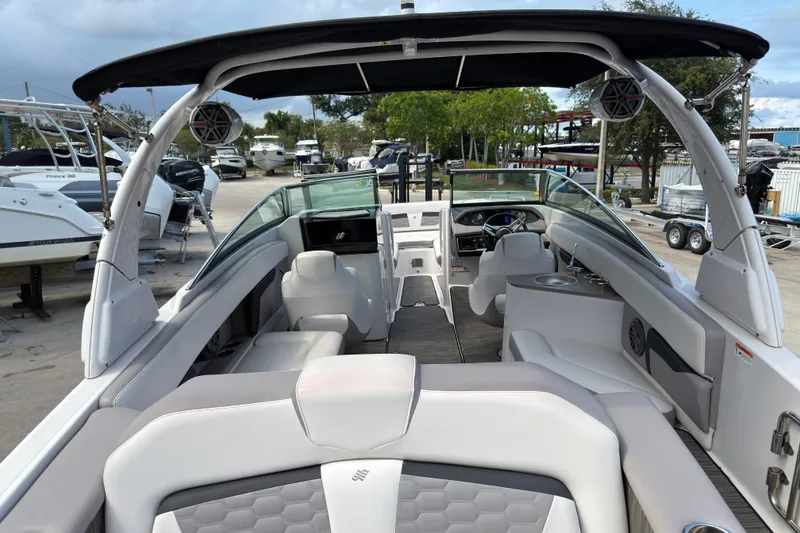 Slide: The Image of 2018 Four Winns HD270 OB boat interior with seating and steering console. - 2