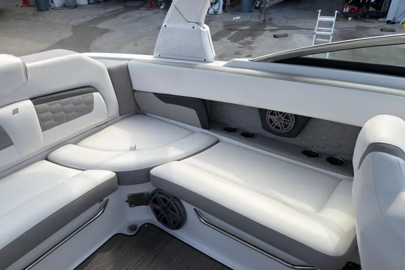 Slide: The Image of Interior of 2018 Four Winns HD270 OB boat with white seating and speaker system. - 9
