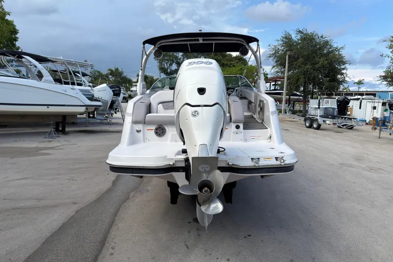 Slide: The Image of 2018 Four Winns HD270 OB boat, rear view with outboard motor, parked in marina. - 18