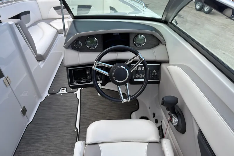 Slide: The Image of 2018 Four Winns HD270 OB boat interior with steering wheel and dashboard controls. - 6