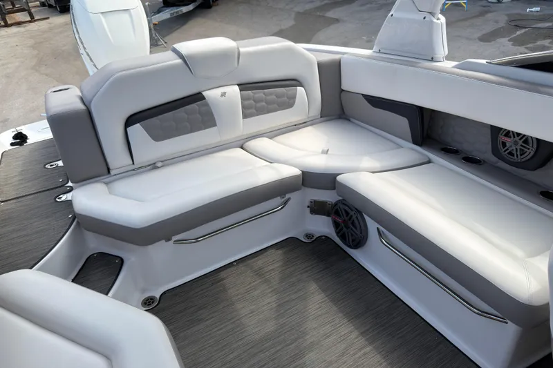 Slide: The Image of 2018 Four Winns HD270 OB boat interior with gray and white seating and speakers. - 10