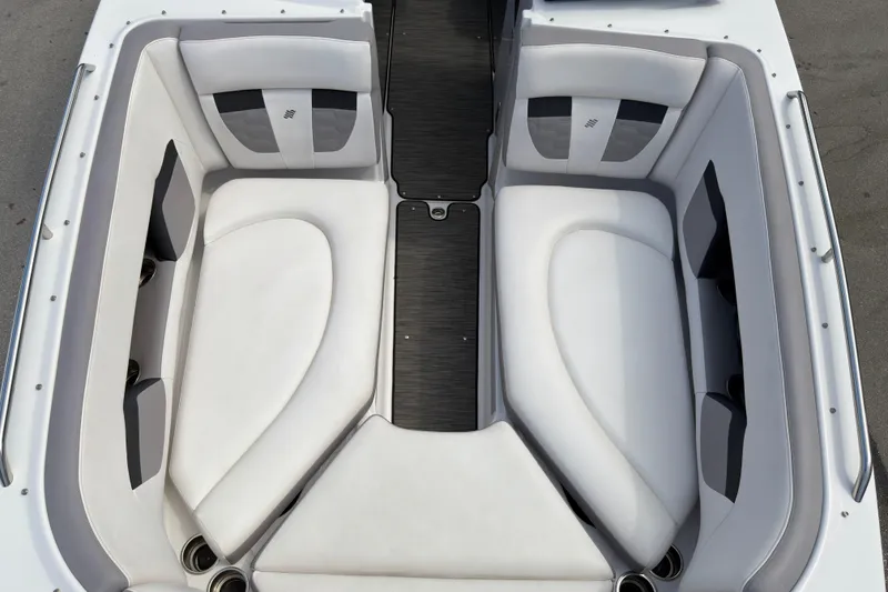 Slide: The Image of 2018 Four Winns HD270 OB boat interior with white cushioned seating. - 14