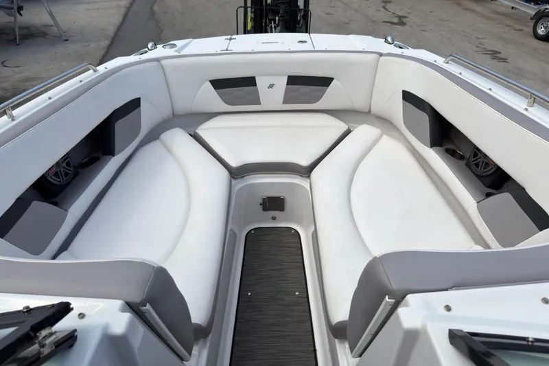 Slide: The Image of 2018 Four Winns HD270 OB boat interior with white cushioned seating and modern design. - 11