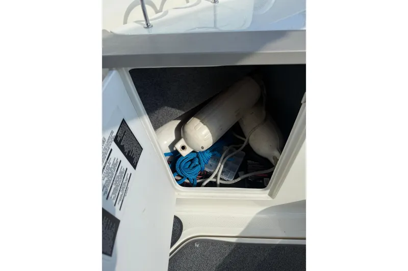 Slide: The Image of Storage compartment of a 2006 Sea Ray 240 Sundancer with ropes and fenders. - 15