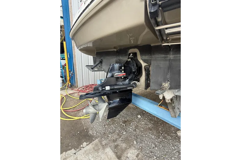 Slide: The Image of 2006 Sea Ray 240 Sundancer boat stern with outboard motor in maintenance area. - 24