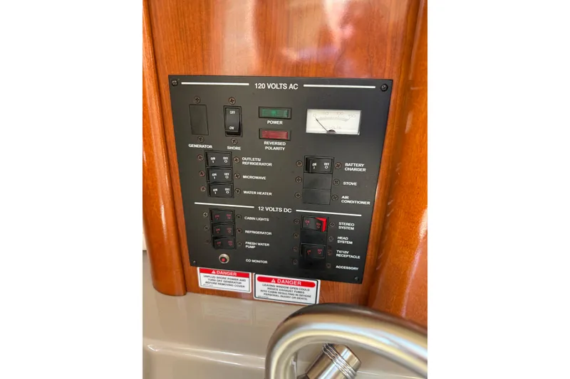 Slide: The Image of Electrical control panel on a 2006 Sea Ray 240 Sundancer boat. - 13