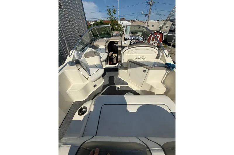 Slide: The Image of 2006 Sea Ray 240 Sundancer boat interior with seating and steering wheel. - 6