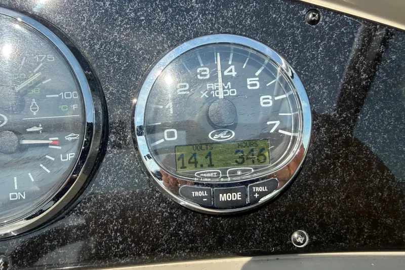 Slide: The Image of Close-up of 2006 Sea Ray 240 Sundancer boat dashboard gauges displaying RPM and voltage. - 3