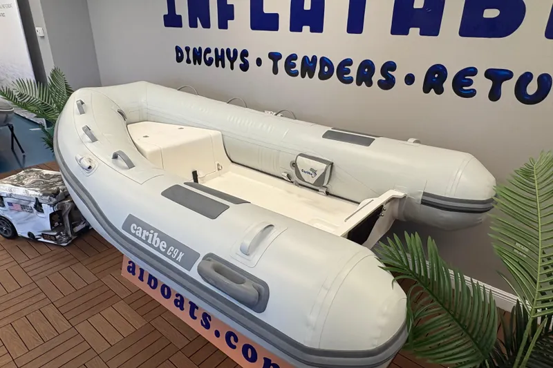 Slide: The Image of Inflatable Caribe C-9X dinghy, 2026 model, displayed indoors with promotional signage. - 4