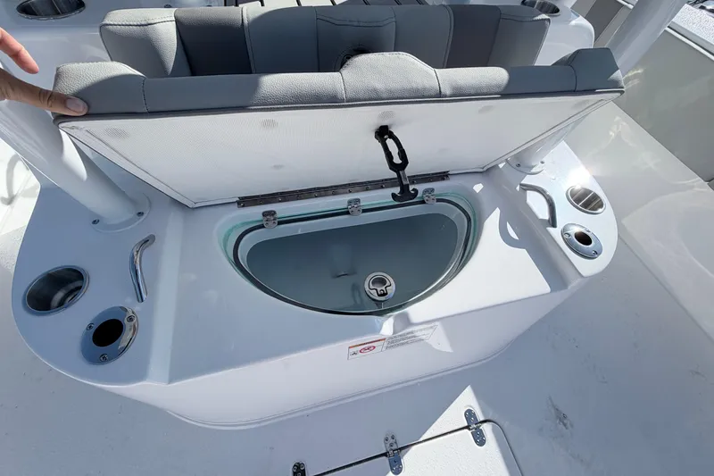 Slide: The Image of Open storage compartment on 2026 Cape Horn 39XS boat, featuring cup holders and seating. - 26