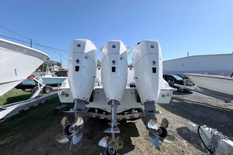 Slide: The Image of 2026 Cape Horn 39XS boat with triple outboard engines, displayed outdoors on a sunny day. - 4