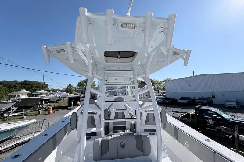 Slide: The Image of 2026 Cape Horn 39XS boat interior with seating and rod holders, displayed outdoors. - 6