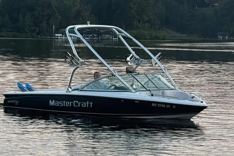 Slide: The Image of 2005 MasterCraft ProStar 197 boat on a calm lake at sunset. - 9