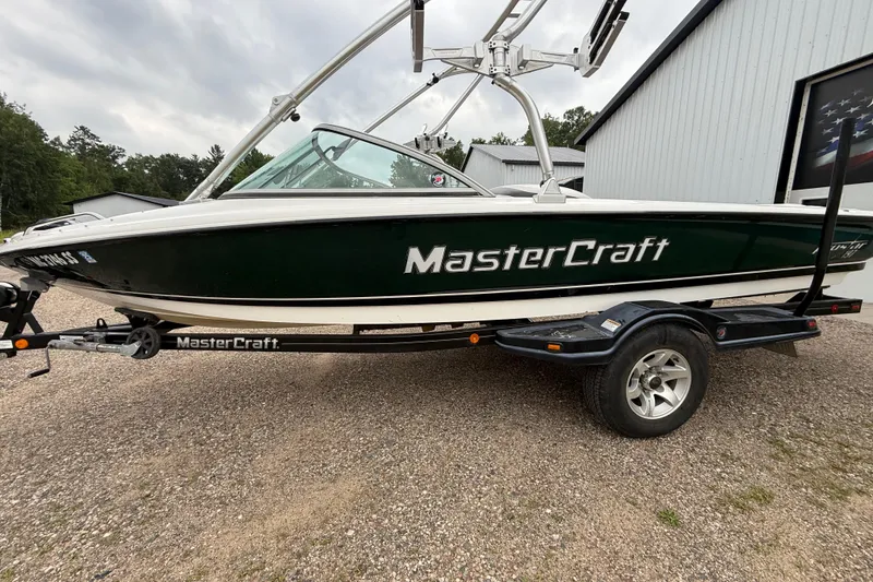 Slide: The Image of 2005 MasterCraft ProStar 197 boat on trailer, parked outdoors near a building. - 7