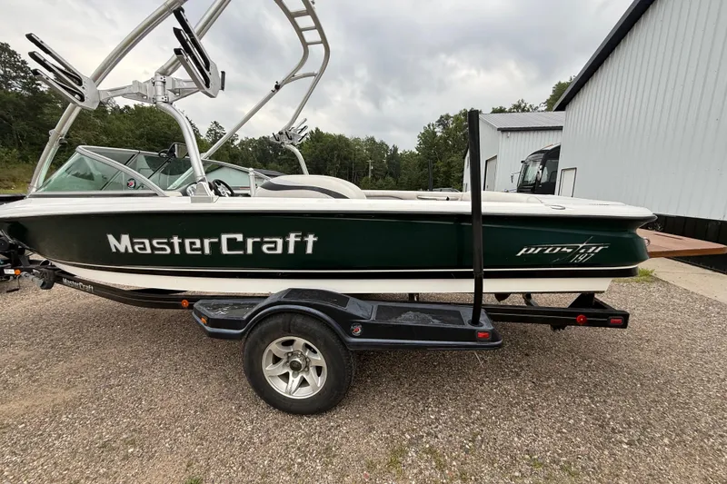 Slide: The Image of 2005 MasterCraft ProStar 197 boat on trailer, parked outdoors near a building. - 6