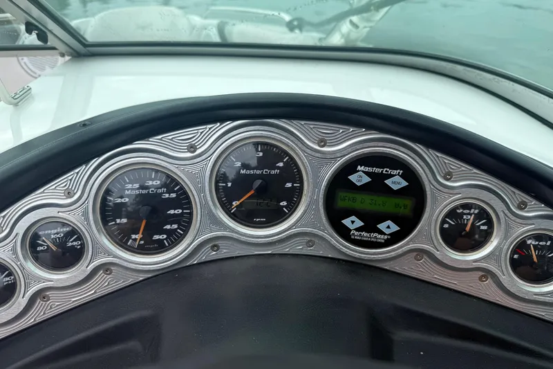 Slide: The Image of Dashboard of a 2005 MasterCraft ProStar 197 boat with gauges and controls. - 10