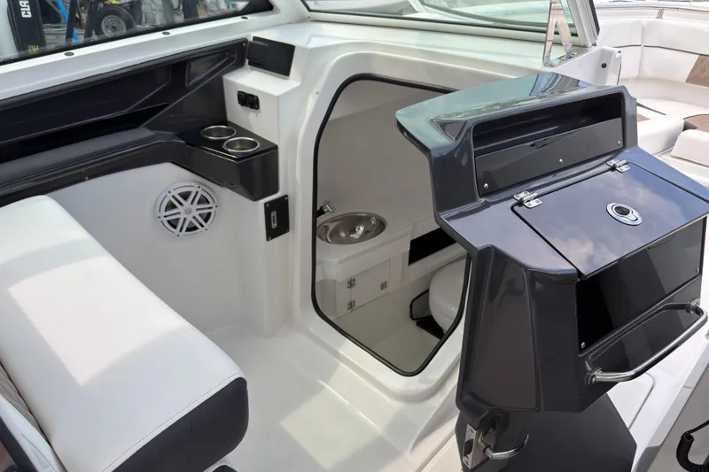 Slide: The Image of 2023 Blackfin 272 DC boat interior with seating, storage, and cup holders. - 11