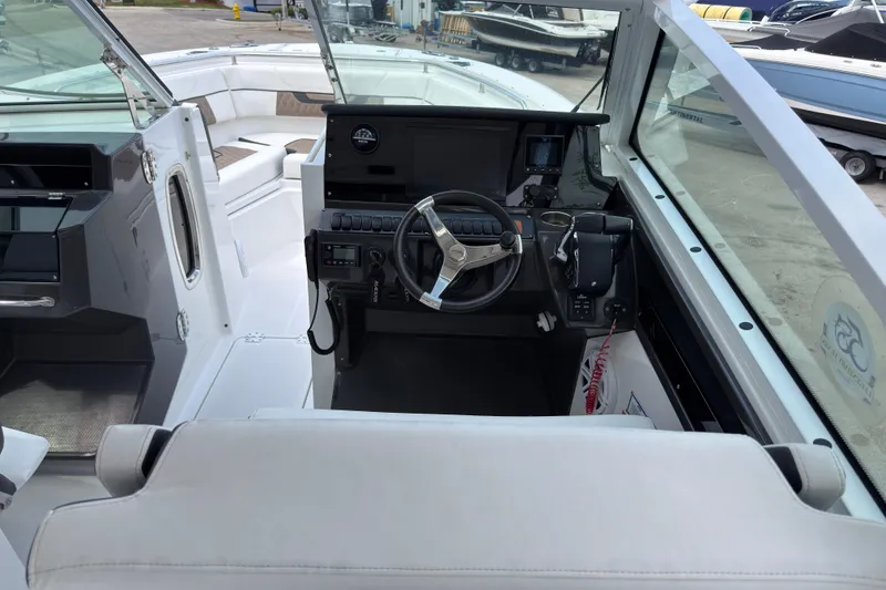 Slide: The Image of 2023 Blackfin 272 DC boat interior with steering wheel and control panel. - 15
