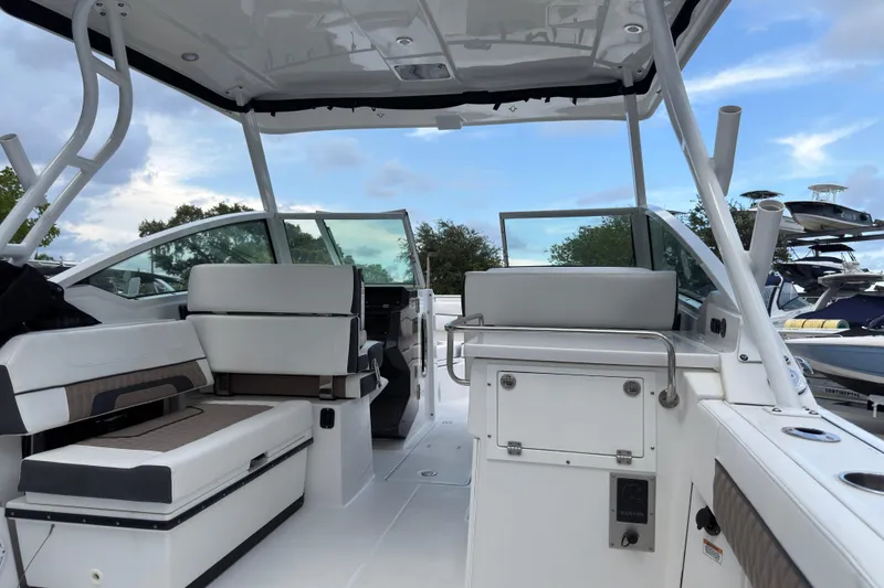 Slide: The Image of 2023 Blackfin 272 DC boat interior with seating and storage, under a clear sky. - 4