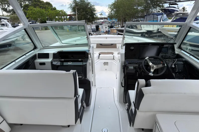 Slide: The Image of 2023 Blackfin 272 DC boat interior with dual consoles and modern steering wheel. - 5