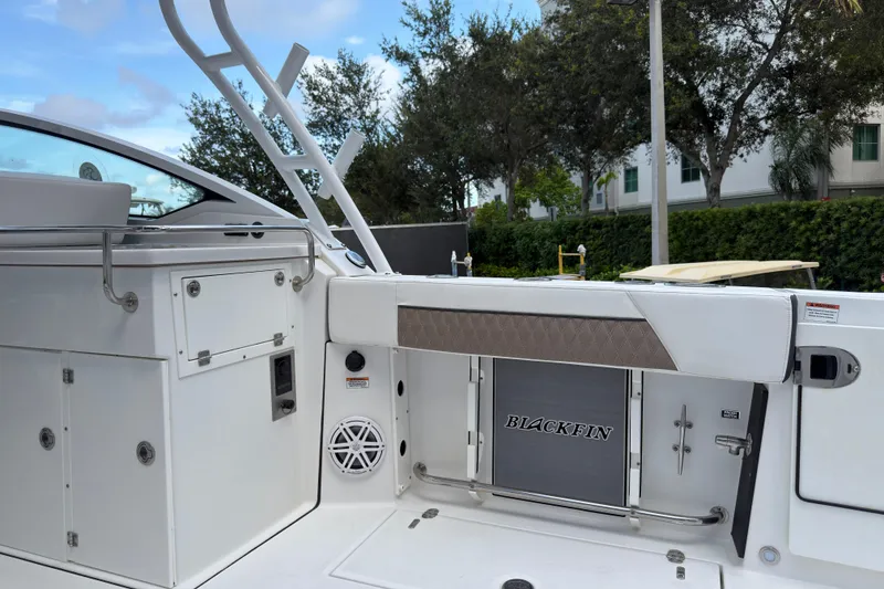 Slide: The Image of 2023 Blackfin 272 DC boat interior with storage compartments and sleek design. - 7