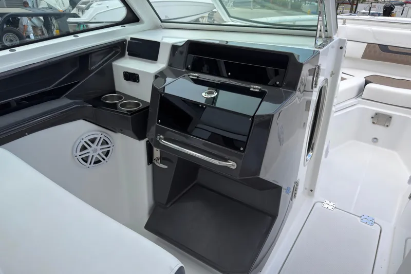Slide: The Image of Interior of 2023 Blackfin 272 DC boat, featuring sleek console and cup holders. - 10