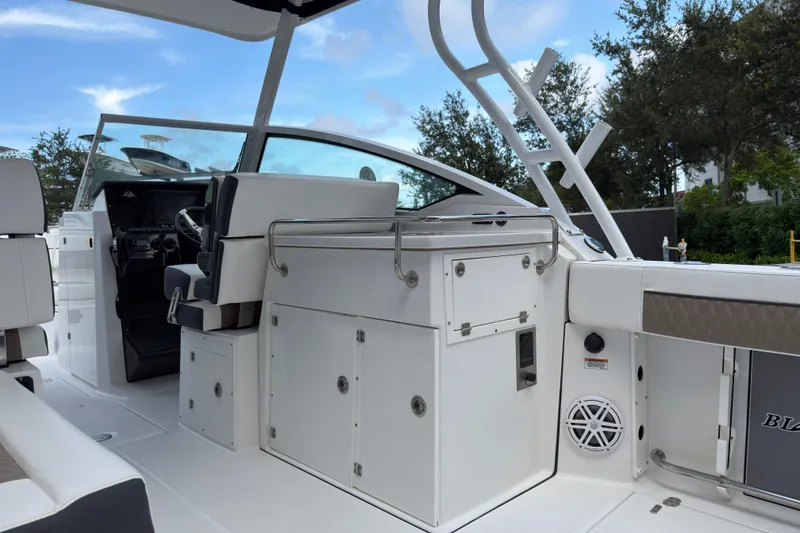 Slide: The Image of 2023 Blackfin 272 DC boat interior with helm, seating, and storage compartments. - 16