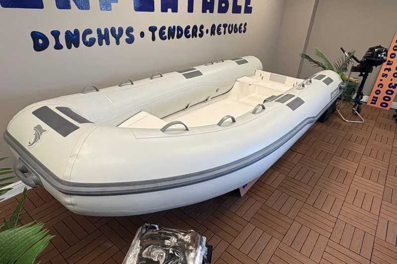 Slide: The Image of Inflatable Caribe C-13 dinghy, 2026 model, displayed indoors on wooden flooring. - 5