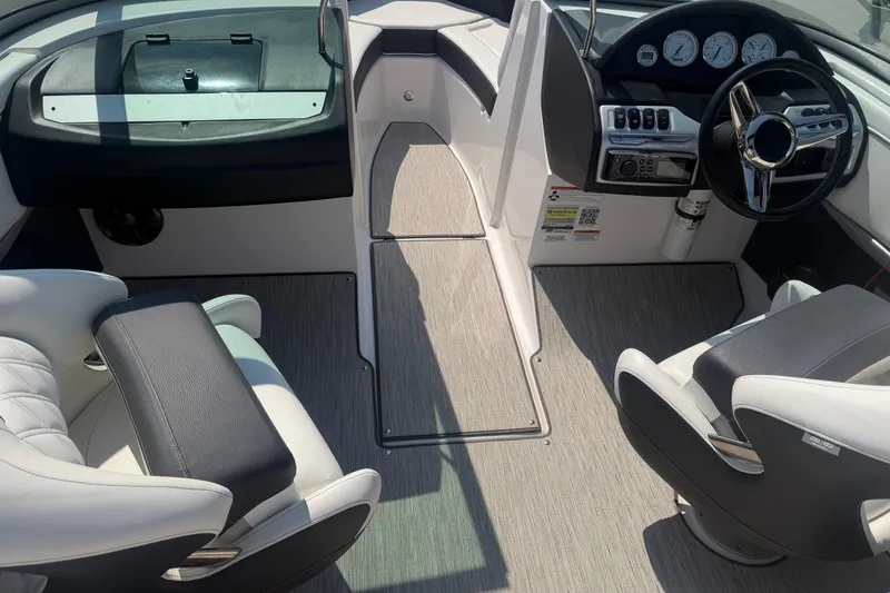 Slide: The Image of Interior of a 2019 Regal 2100 boat featuring modern seating and dashboard controls. - 25