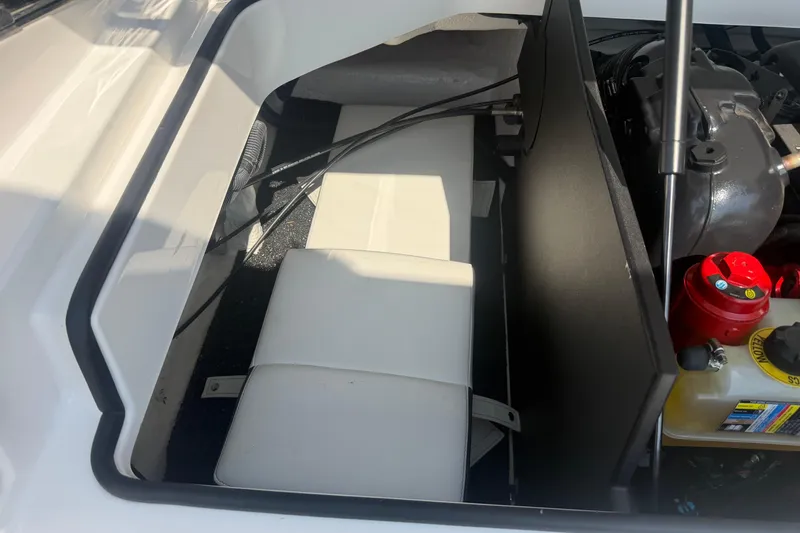 Slide: The Image of 2019 Regal 2100 boat engine compartment with seating and storage area. - 30