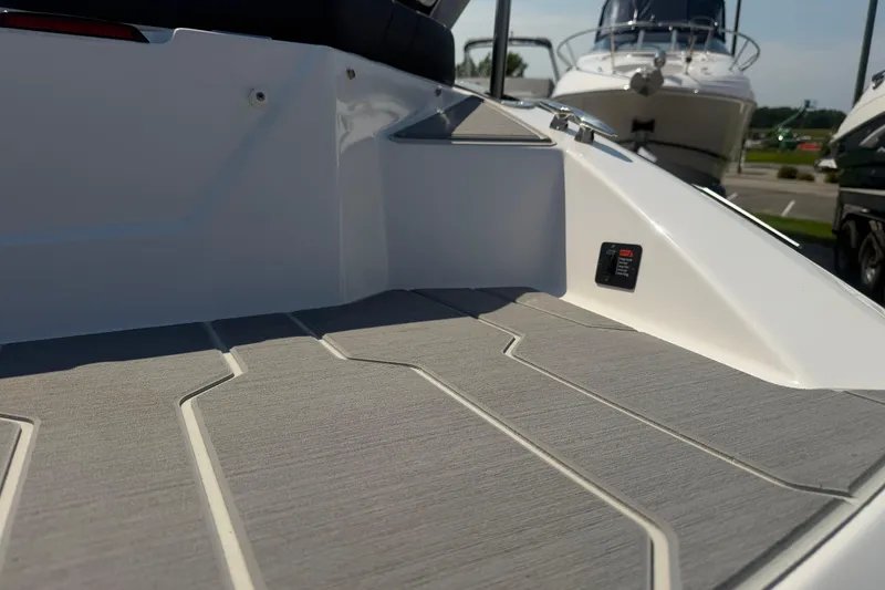 Slide: The Image of 2019 Regal 2100 boat deck with sleek, modern design and textured flooring. - 9