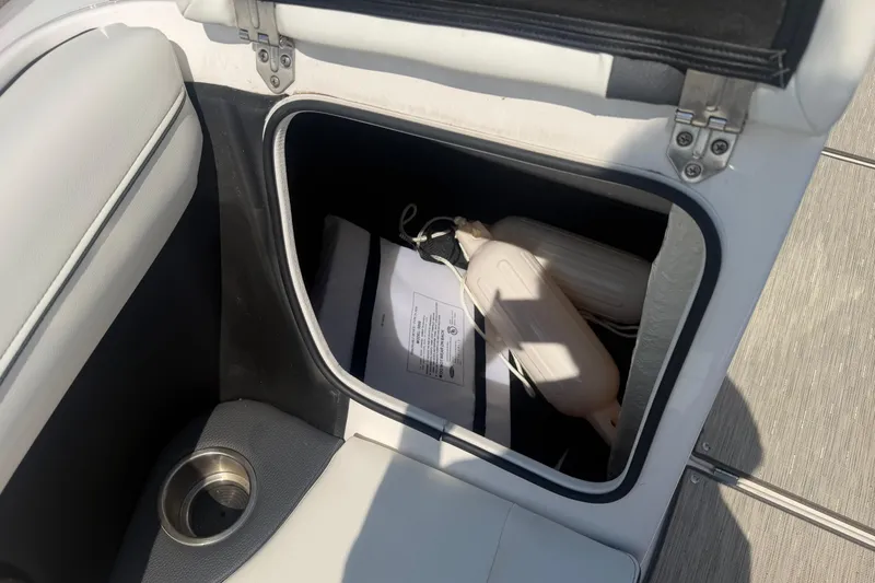 Slide: The Image of Storage compartment in a 2019 Regal 2100 boat with fenders and documents. - 20