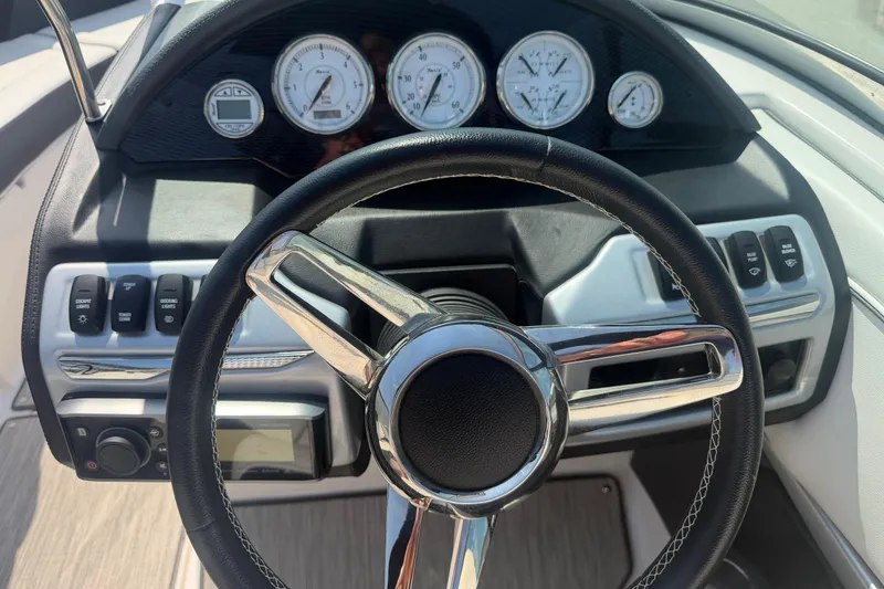 Slide: The Image of Steering wheel and dashboard of a 2019 Regal 2100 boat. - 11