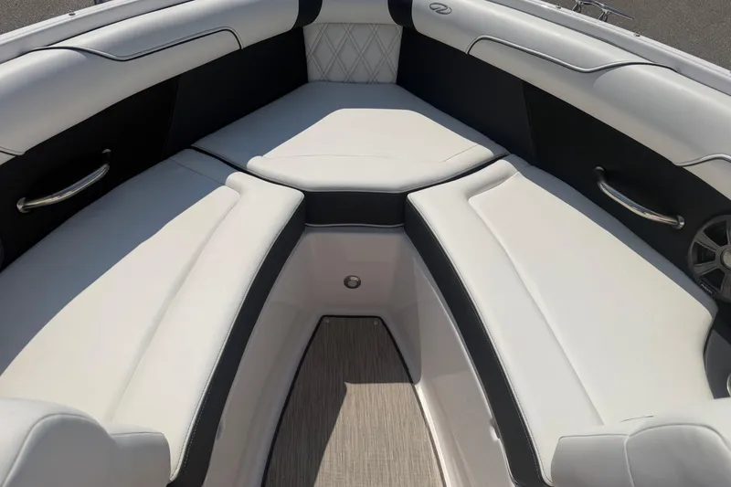 Slide: The Image of 2019 Regal 2100 boat interior with white cushioned seating and stainless steel handles. - 8