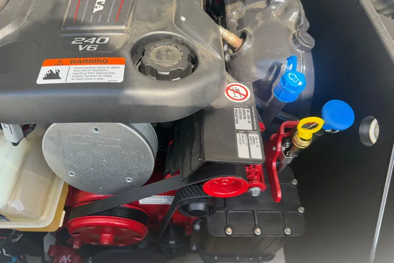 Slide: The Image of 2019 Regal 2100 engine close-up, featuring a 240 V6 with warning labels. - 31