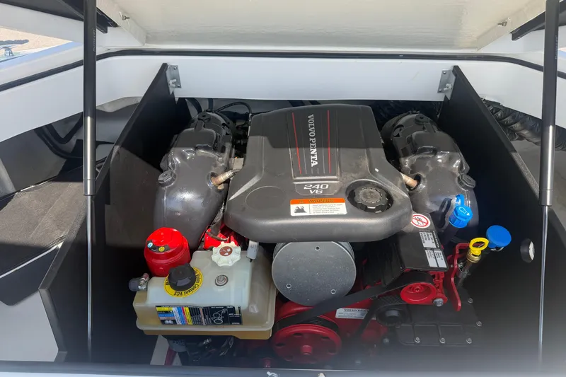 Slide: The Image of Engine compartment of a 2019 Regal 2100 boat featuring a Volvo Penta 240 V6 engine. - 32