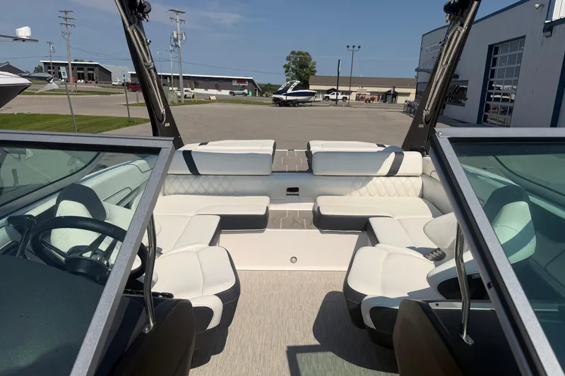 Slide: The Image of Interior view of a 2019 Regal 2100 boat with white seating and steering wheel. - 26