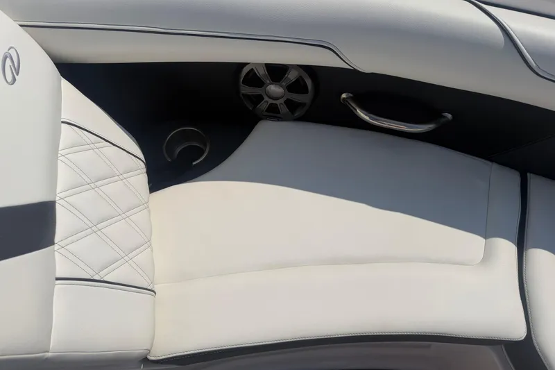Slide: The Image of Interior of a 2019 Regal 2100 boat featuring white leather seating and speaker. - 21