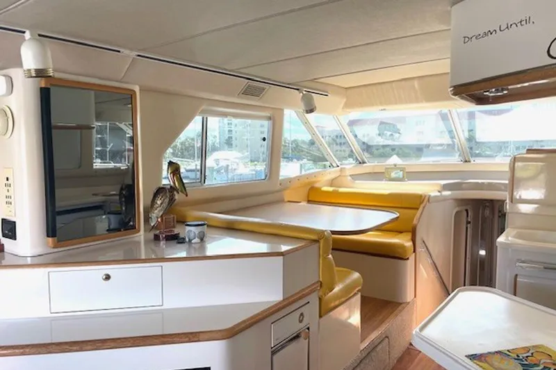 Slide: The Image of Interior of a 1996 Sea Ray 500 Sedan Bridge yacht with yellow seating and modern decor. - 15