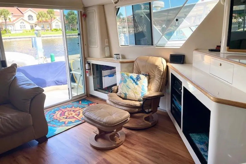 Slide: The Image of Interior of 1996 Sea Ray 500 Sedan Bridge with cozy seating and waterfront view. - 14