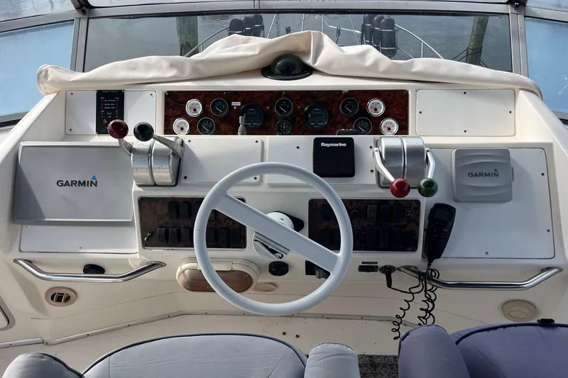 Slide: The Image of 1996 Sea Ray 500 Sedan Bridge helm with Garmin and Raymarine navigation systems. - 26