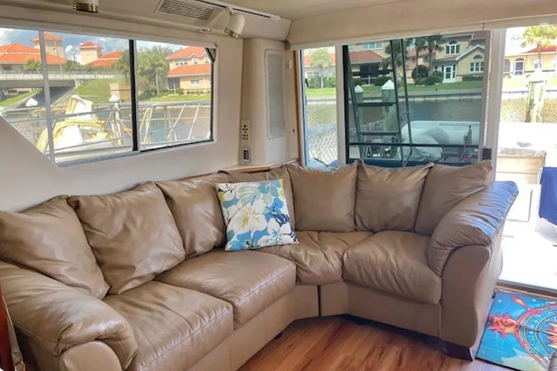 Slide: The Image of Luxurious interior of 1996 Sea Ray 500 Sedan Bridge with leather sofa and scenic windows. - 11