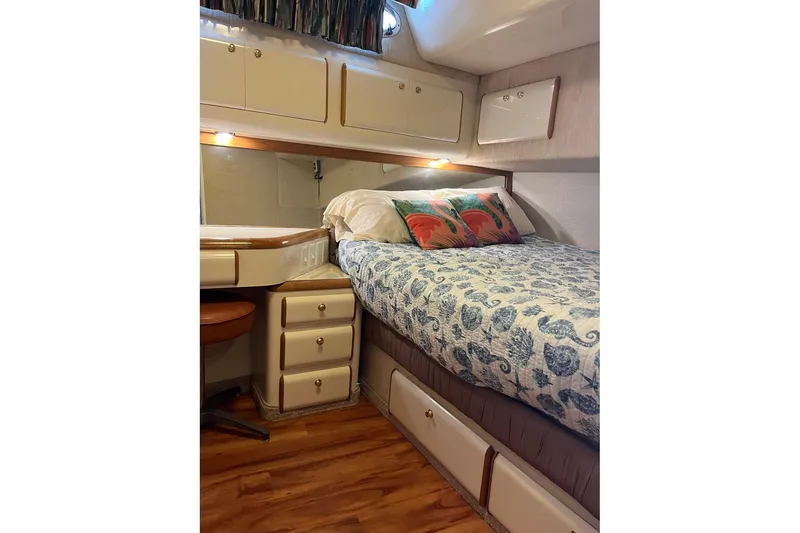 Slide: The Image of Cozy cabin interior of 1996 Sea Ray 500 Sedan Bridge with bed and storage. - 6